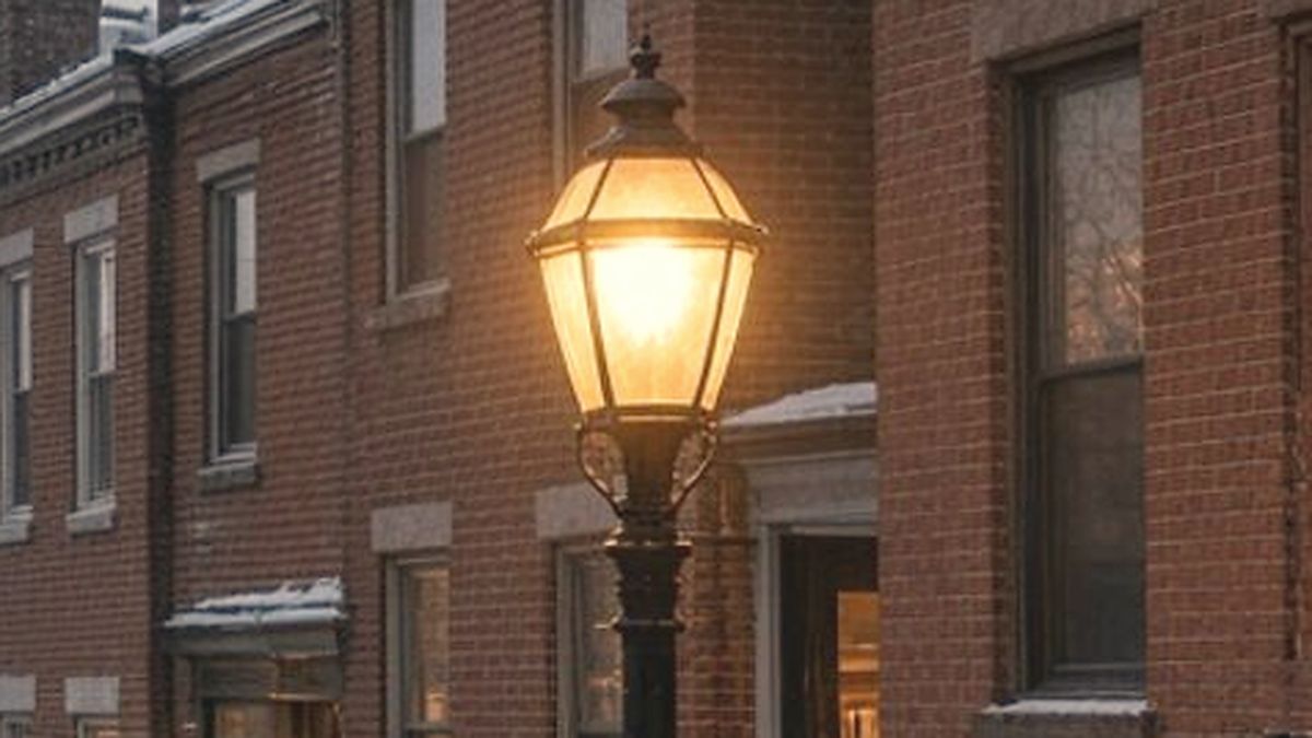 Row of brick East End homes with front steps and a gas-style street lamp